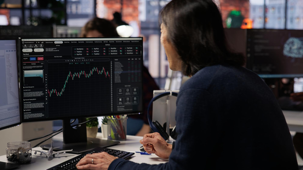 A focused beginner trader learn about trading, highlighting the educational support offered by the best prop firm for beginners